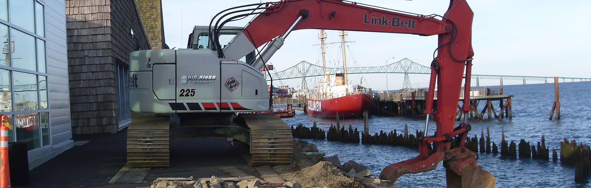 hydraulic excavator digging riverfront shoreline